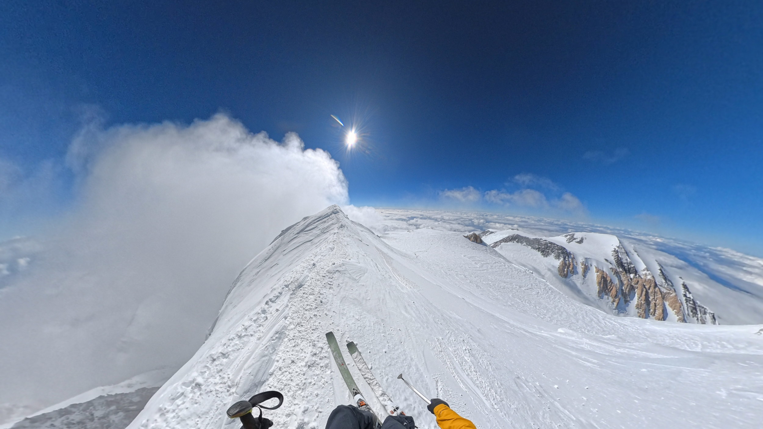 Skiing down the summit ridge